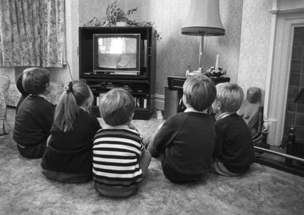 A group of young British children watching television in October 1988. (Photo by Express/Getty Images)